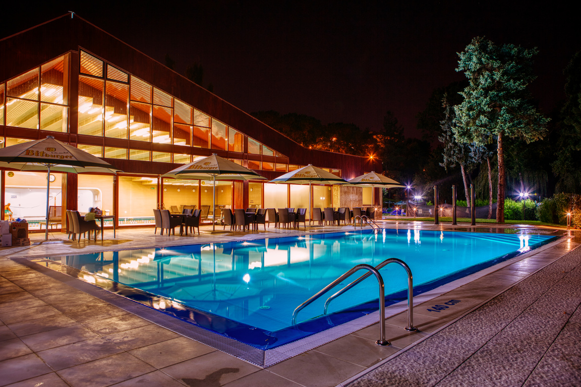 Illuminated Swimming Pool Near the Glass Structure
